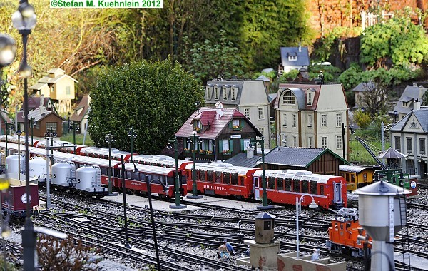 Blick zum Bahnhof. Die Z�ge rollen auf der Gartenbahnanlage